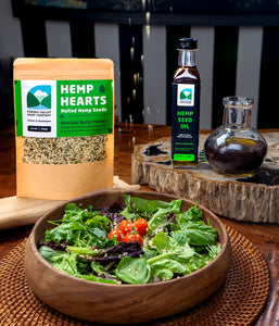 Hemp seed and Hemp seed oil displayed with a salad which can be made by adding hemp products