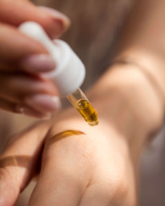 Hemp oil being applied on wrist with a dropper