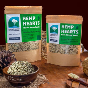 Two Hemp heart packets placed next to each other with bowl full of Hemp hearts